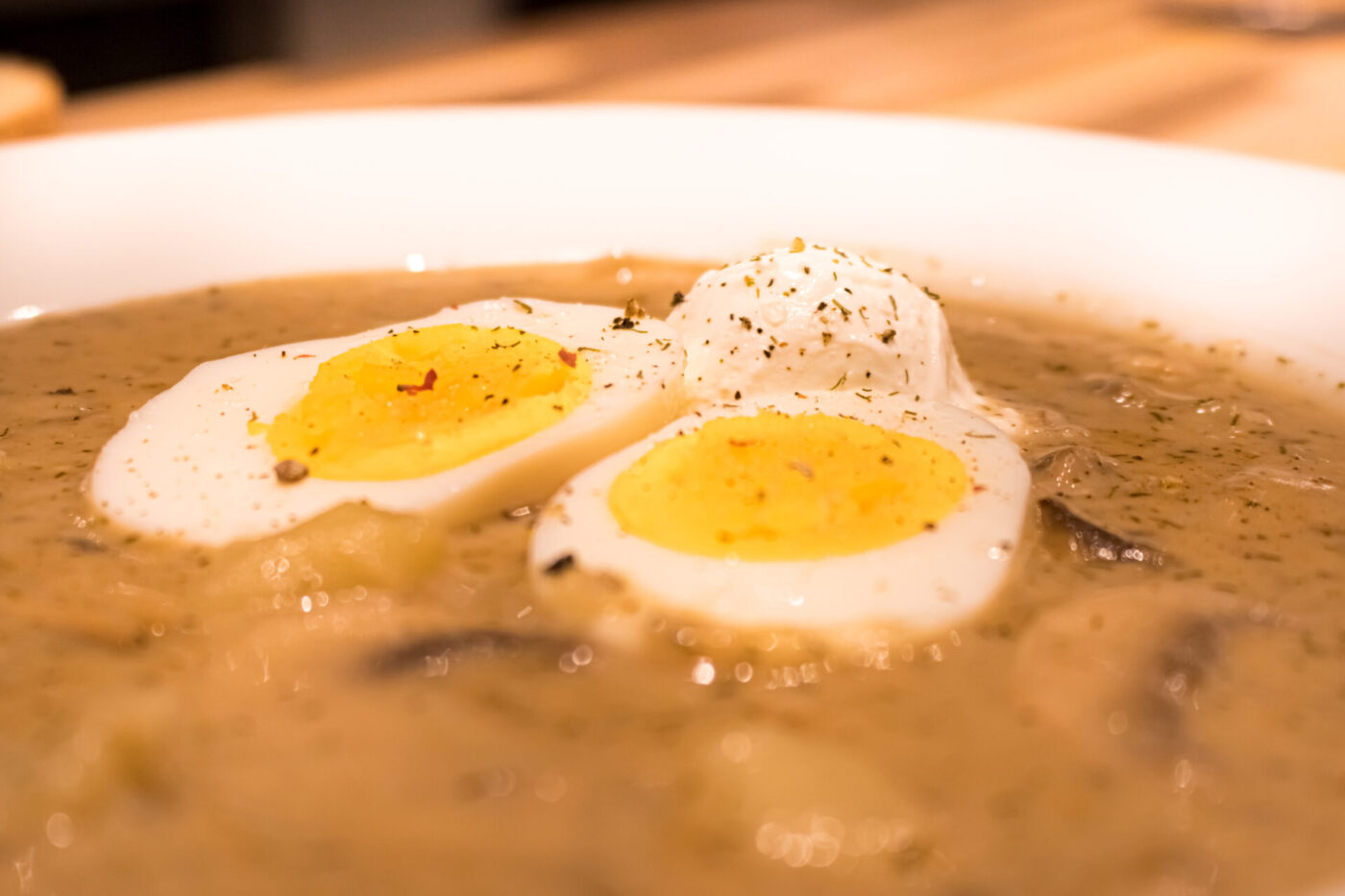 Kulajda Soup Bowl of Kulajda Soup topped with sliced hard-boiled eggs, dill, and cracked pepper.
