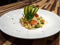 Shopska Salad Shopska Salad with diced tomato, cucumber, feta, and green pepper, topped with curled cucumber ribbons.