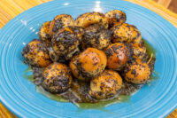 Bobalky with Poppyseeds and Honey piled on a blue plate with glaze pooling beneath