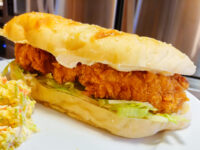 Crispy Chicken Tenders fillet in a bread roll with lettuce and mayo, coleslaw served alongside