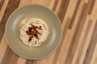 Halušky with Bryndza, small dumplings in white cheese sauce topped with crisp bacon and parsley.