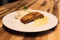 Seared Salmon in Mustard Sauce fillet plated with mashed potato and pale mustard cream sauce.