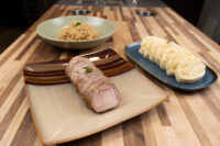 Sliced pork, a bowl of sauerkraut, and rounds of dumpling for Pork-Sauerkraut-Dumpling (Vepřo-knedlo-zelo).