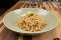 Bowl of stewed sauerkraut, the sauerkraut portion of Pork-Sauerkraut-Dumpling (Vepřo-knedlo-zelo), garnished with a sprig of parsley.