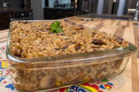 Glass dish of baked Mushroom Kuba (Houbovy Kuba) with barley and mushrooms, topped with parsley.