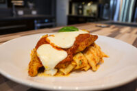 Breaded Chicken Parmesan topped with melted mozzarella and marinara, served over tube pasta.