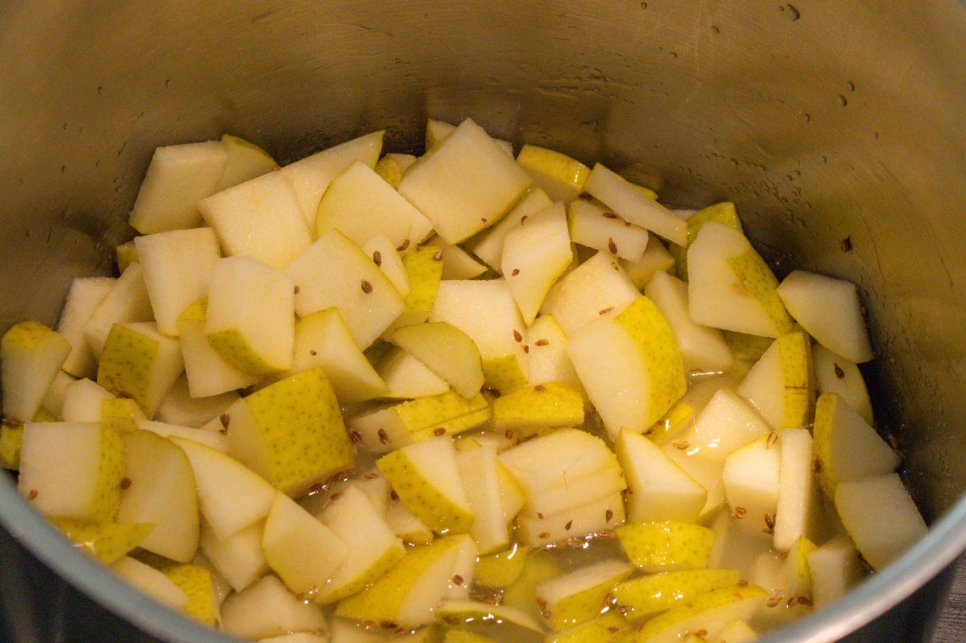 Diced unpeeled pears with anise seeds simmering in liquid, pot for Frgal Kolach with Pear Filling