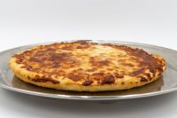 Round 60 min. Pan Pizza with a thick golden crust and browned cheese top on a metal plate.
