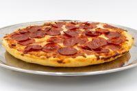 A 60 min. Pan Pizza with a thick golden crust, melted cheese, and pepperoni, on a metal tray.