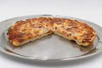 Thick-crust 60 min. Pan Pizza with melted cheese, sliced into wedges, on a round metal pan.