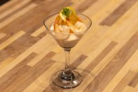 Shrimp Cocktail served in a martini glass with creamy sauce, lemon twist, and parsley sprig.